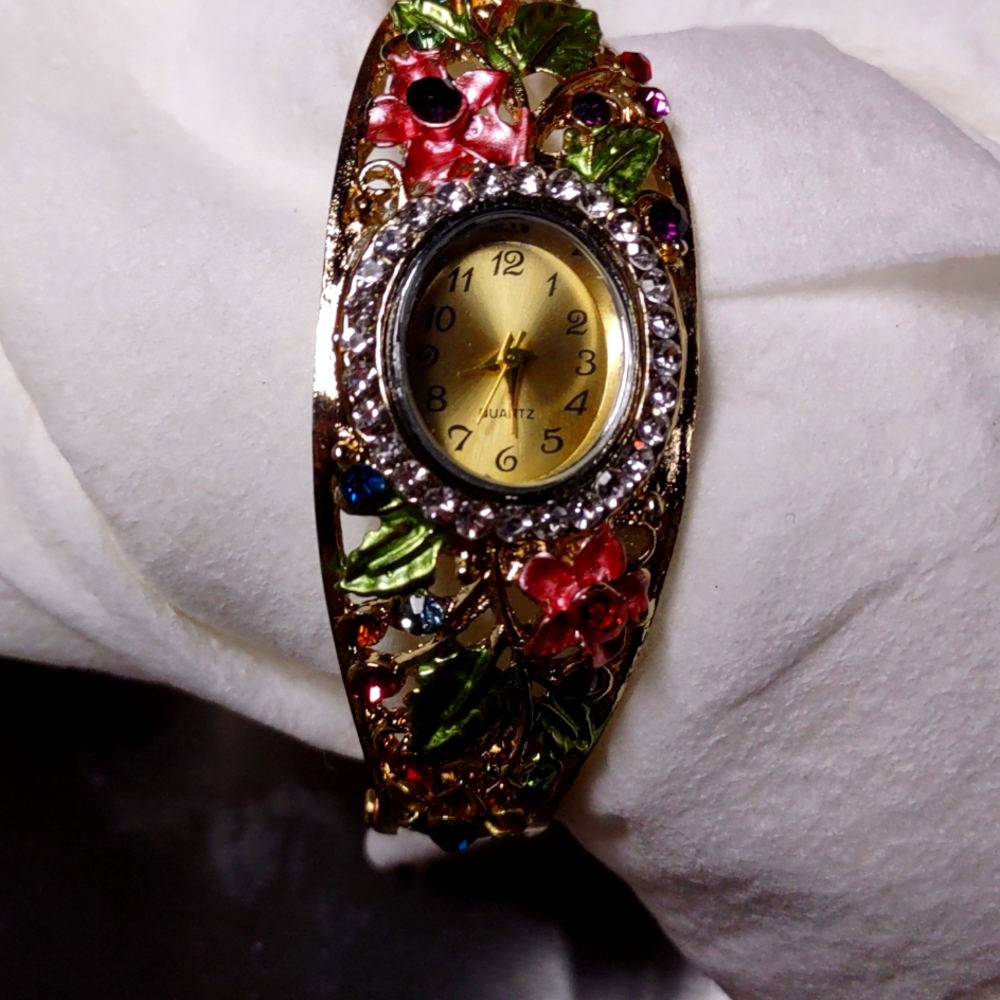 Bracelet style  floral gold colored crystal watch.